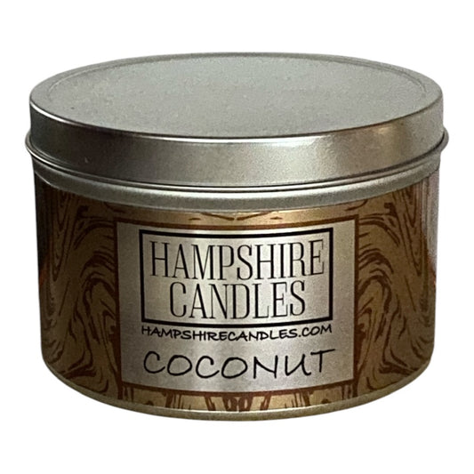 Coconut scented soy wax candle tin with a creamy white label, evoking tropical vibes.
