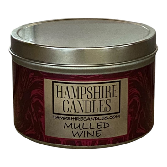 Mulled Wine scented candle tin with festive red label, offering a warming seasonal aroma.