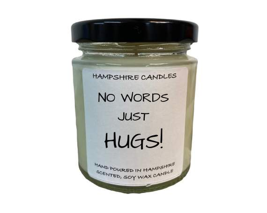 "No Words, Just Hugs candle in a 190ml clear glass jar with a sleek black lid, packaged in a luxury gift box."
